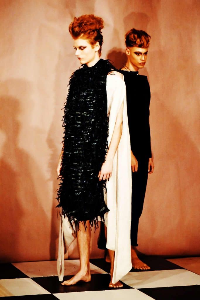 Sustainable luxury genderless couture layered with sustainable leather feather dress and black tunic