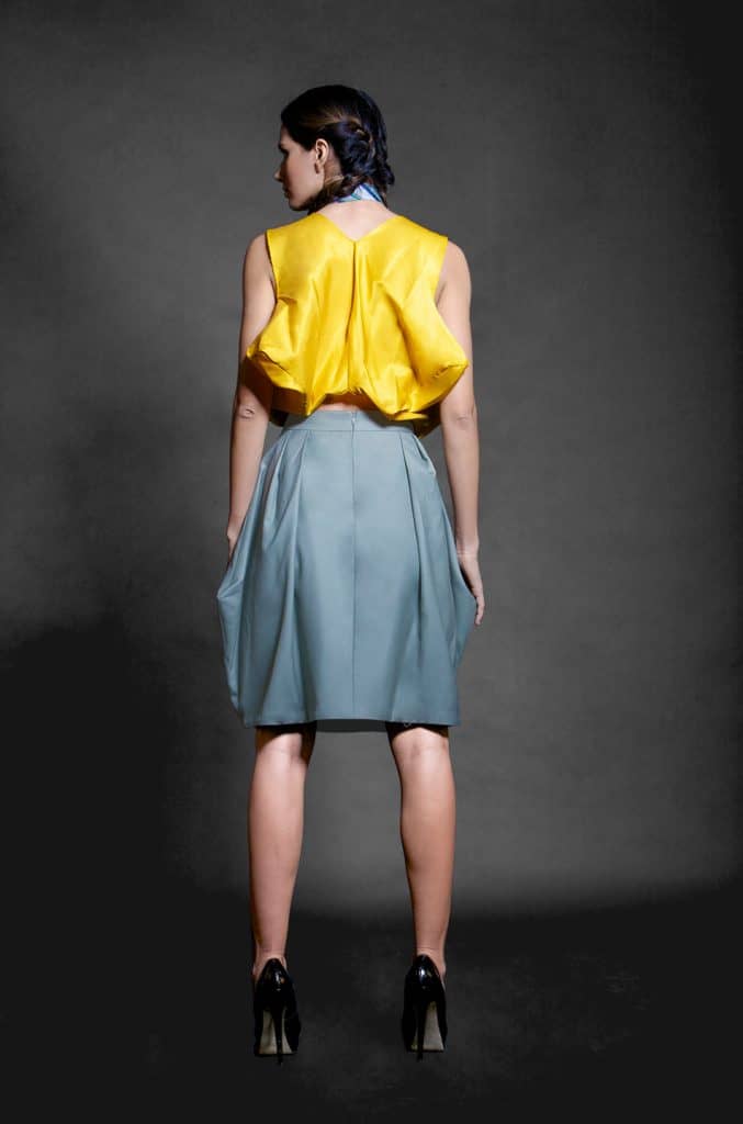 Women’s rtw yellow silk blouse with an ash green skirt back view
