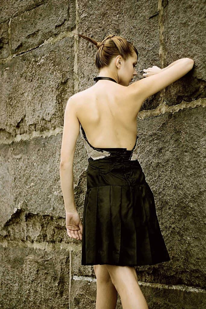 Women’s rtw up-cycled black skirt with a beige top thinking